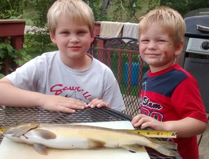 Two of my boys and an 18 inch brown trout they caught in a creek near where we live.  Because of Mercury pollution from coal-burning power stations, the boys can eat a serving of fish like this no more than once a week.
